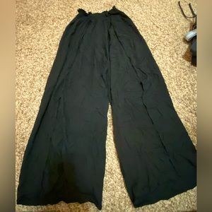 black flowy pants with elastic band and slits up the legs